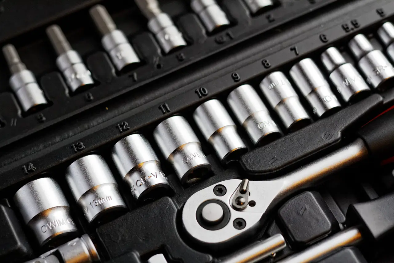 A socket wrench set laid out in a dark case